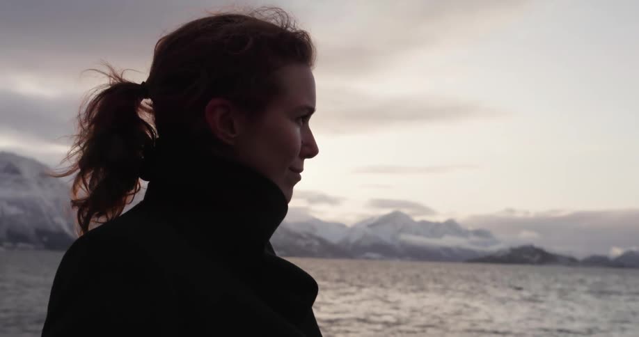 Side view of a woman looking at the lake