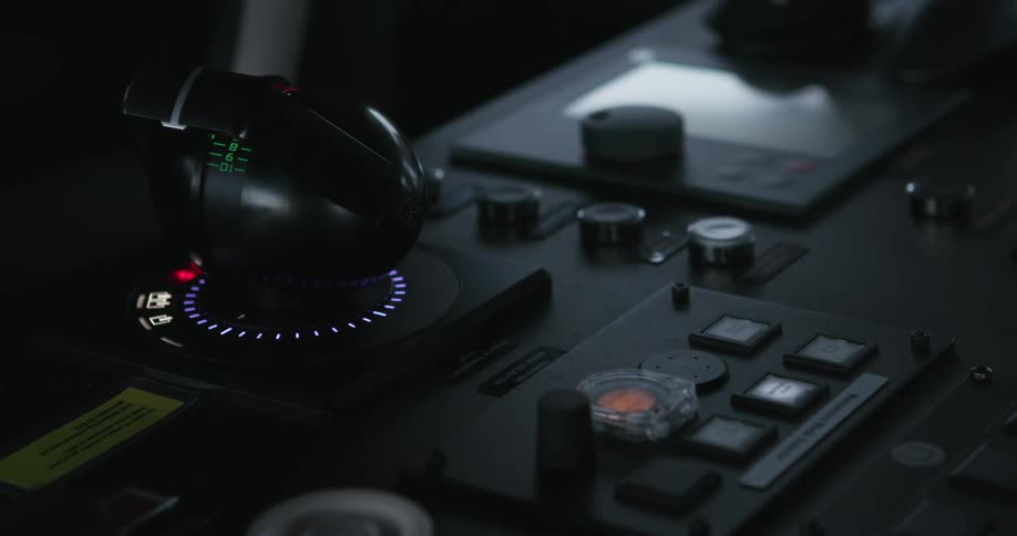 An air traffic controller pushes a button on a control panel