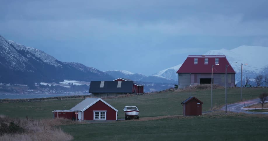 A boat sits next to a building on the property of a homestead
