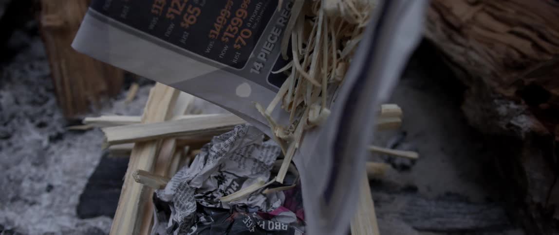 Kindling is put on a stacked fire starter