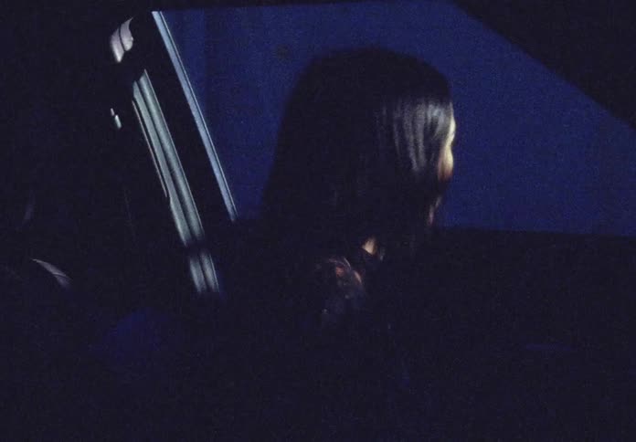 Woman gets out of the car at night