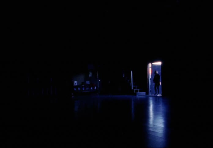 A woman walks into the large studio