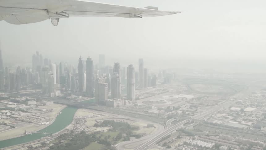 A view of a river and city skyline from inside of an airplane