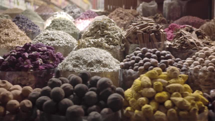 Piles of fruit and vegetables sit in bins at a market