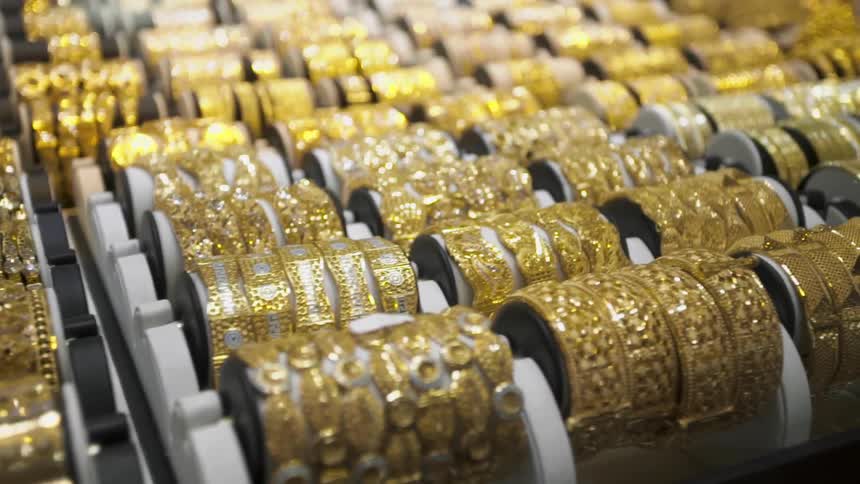 Rows of jeweled bracelets in a store display case