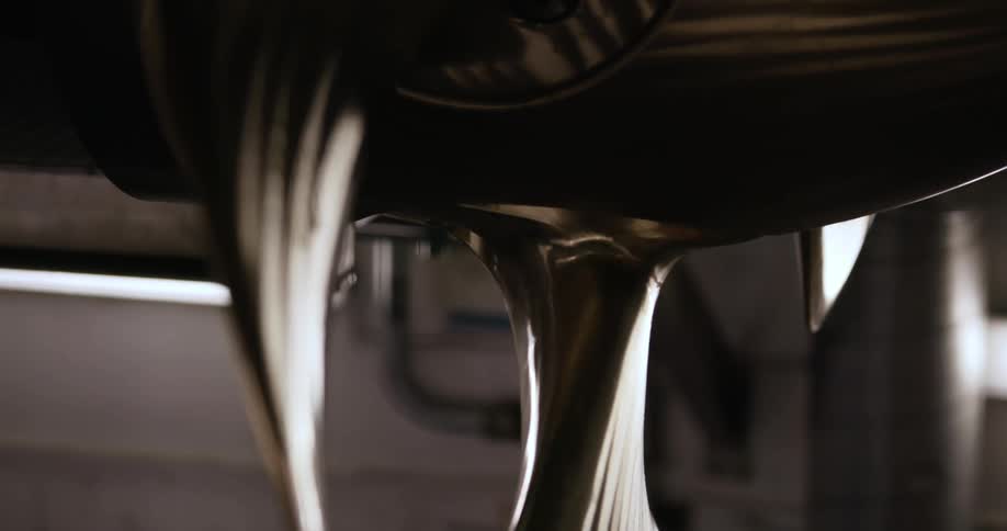 The curved metal blades of a machine propeller or fan reflect light