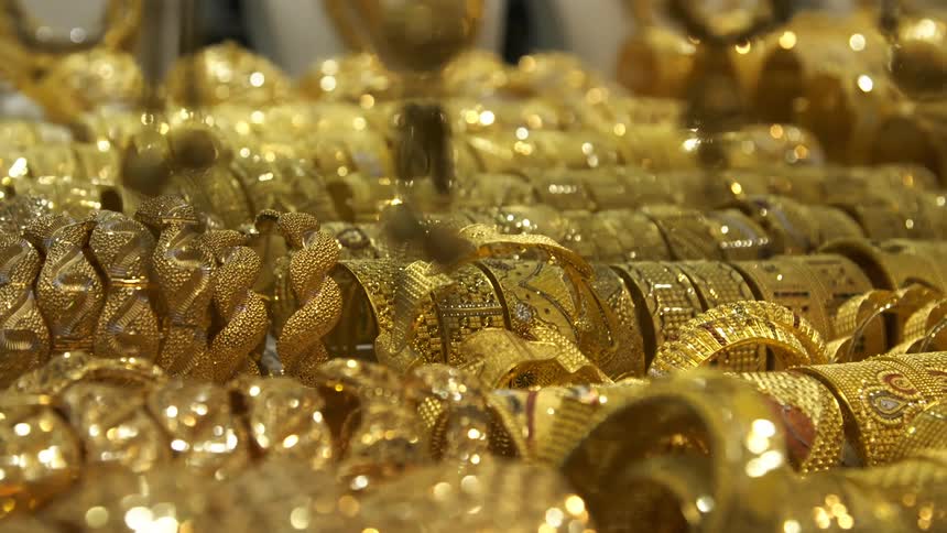Rows and rows of gold bracelets and pendants covered in precious stones