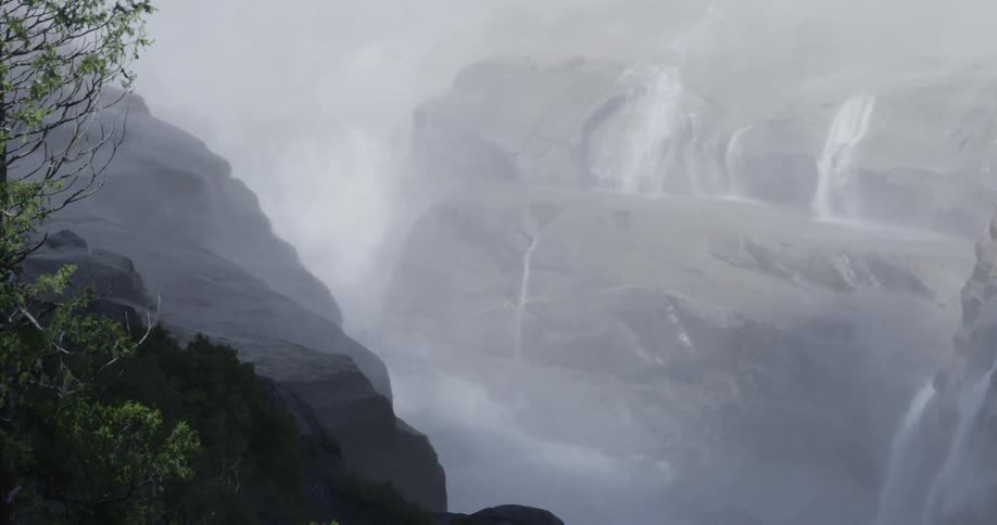 A foggy mist covers the area near a waterfall