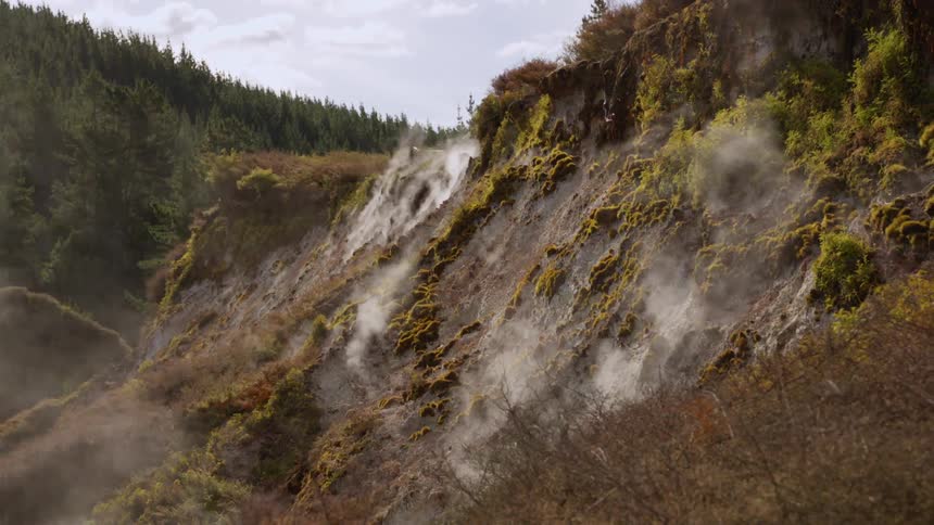 Steam rises up the side of the mountain