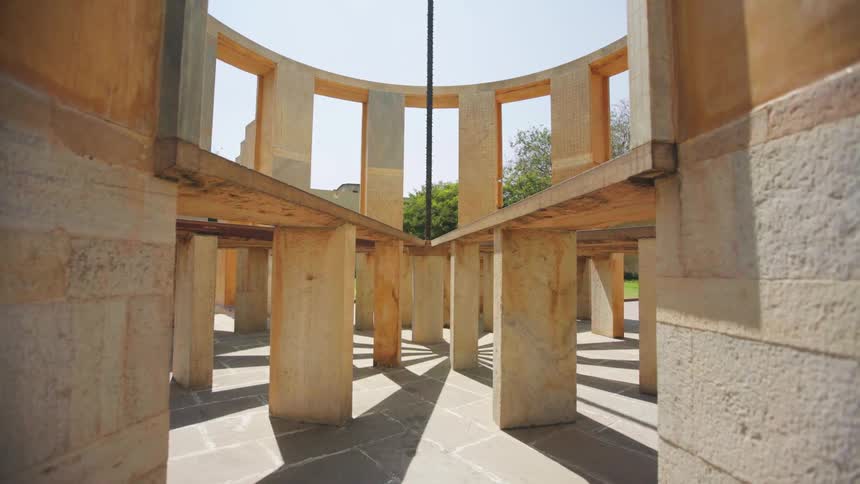 A structure built out of stone and wood takes shape outdoors