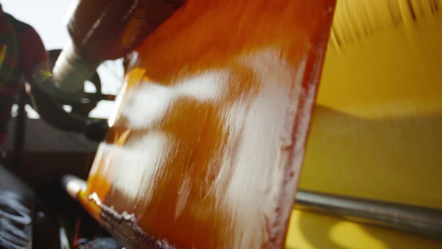 A worker adjusts the fabric on the machine