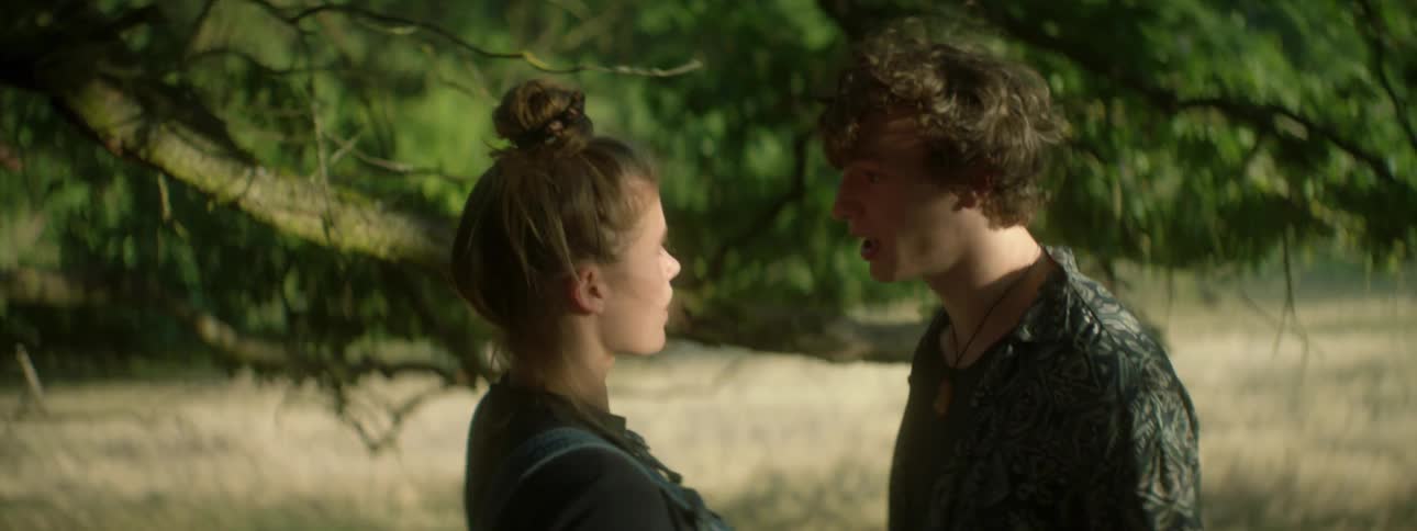 Woman reaches for a man in the forest and he turns and yells at her