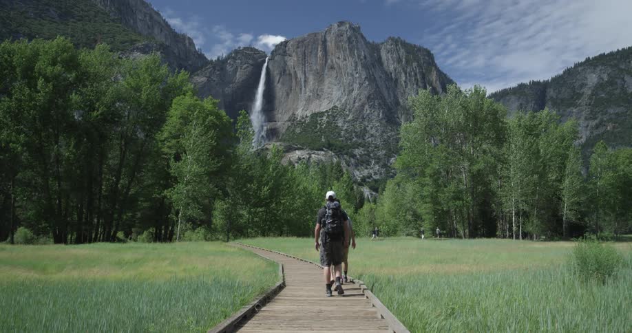 Men walking on a path in a mountain valley