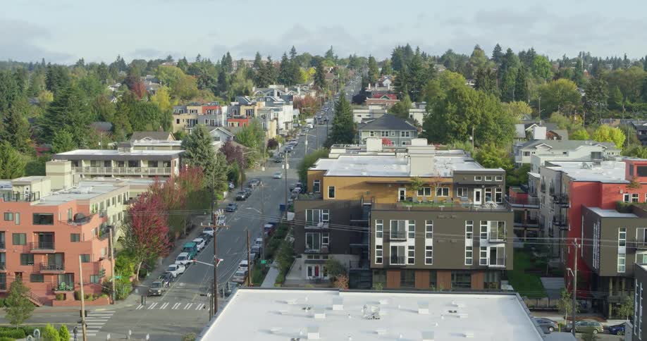 Traffic moves down roads running through a neighborhood
