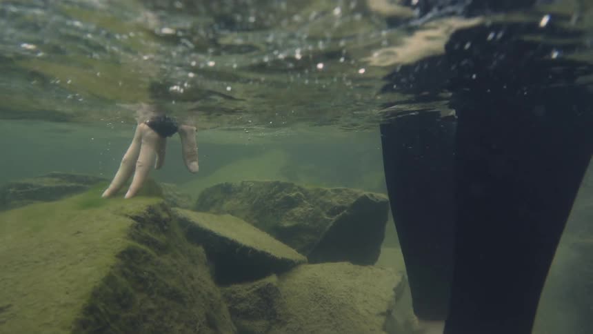 A woman walks through the water