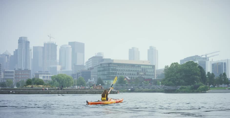 Kayaking in the harbor on a cloudy day in the city