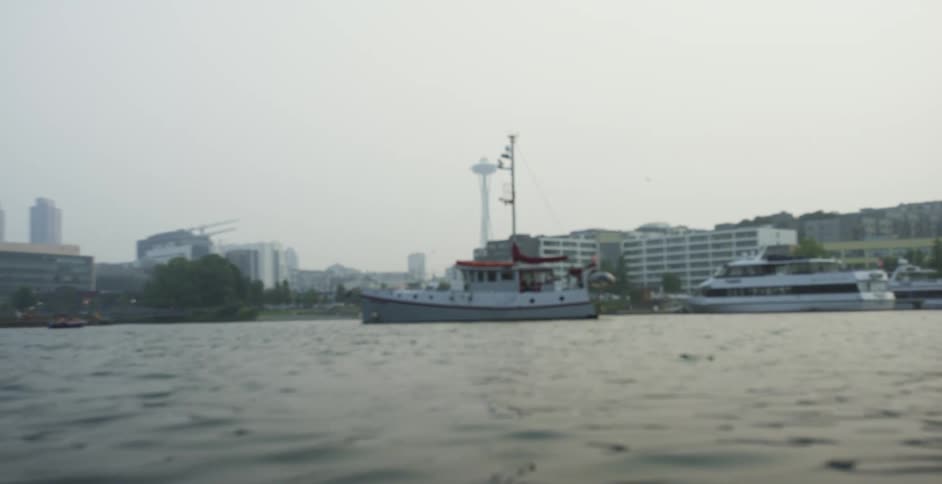 Boats in a body of water with the skyline in the background