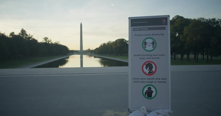 A sign for Covid 19 safety sits in the national mall in washington dc