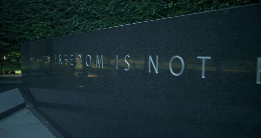 The engraved letters stand out on the dark monument