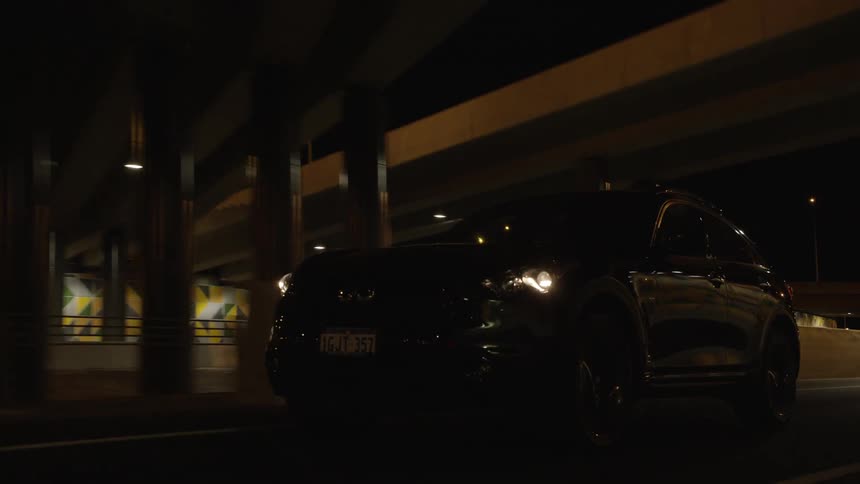 The vehicle is driving down the highway at night