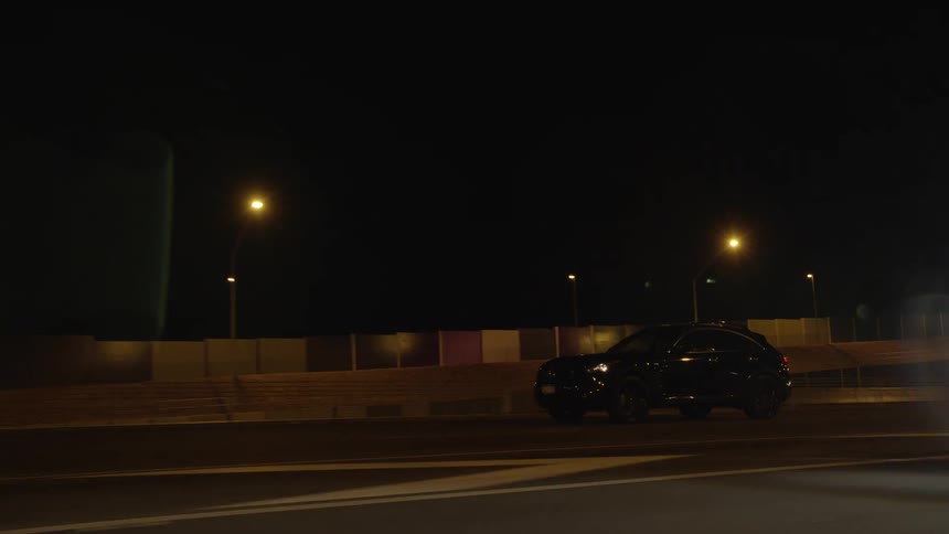 Vehicles drive on highway at night