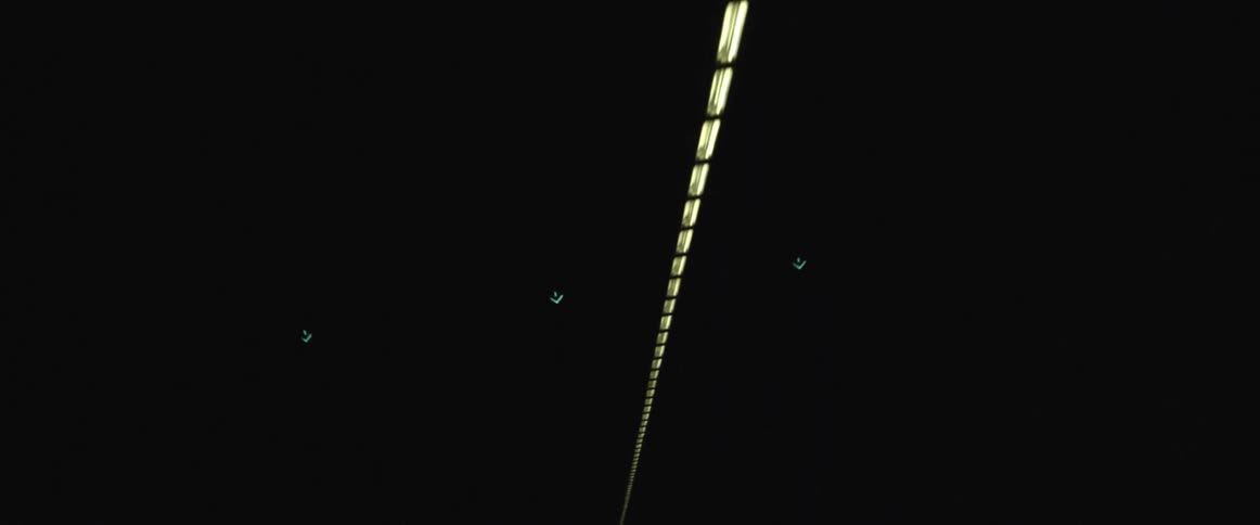 A row of fluorescent lights light up a dark tunnel