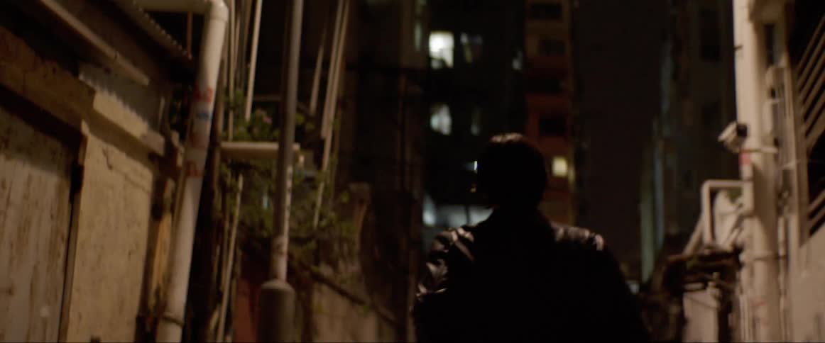 Man runs in the the narrow street at night