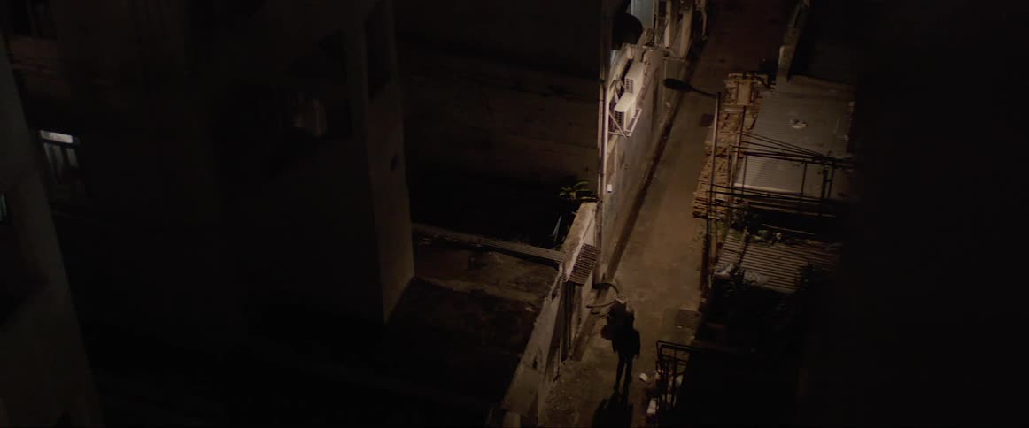 A man walks down a quiet dark street by himself