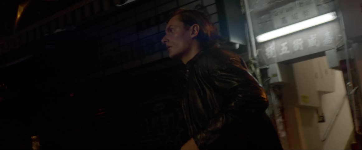 Man looks around and runs in the street at night