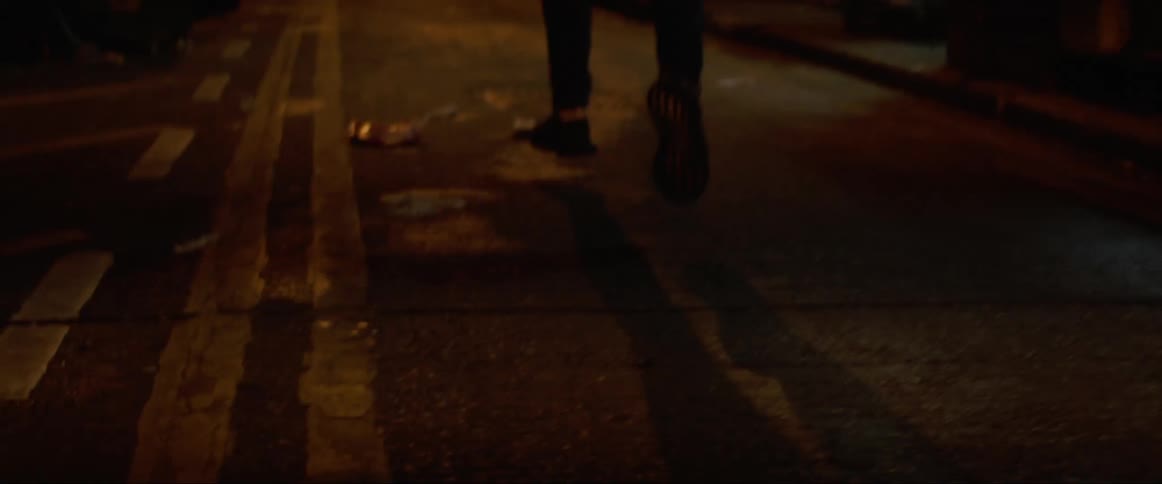 Man runs in the narrow street at night