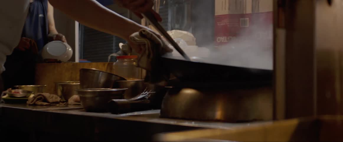 A white man stirs and prepares the food