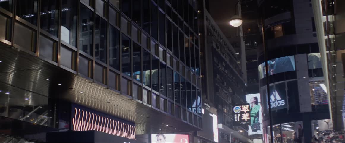 People walking down a city street at night
