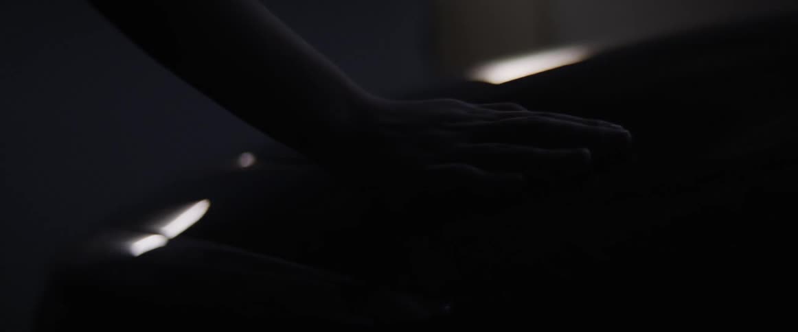 A person traces their hand on the shiny car