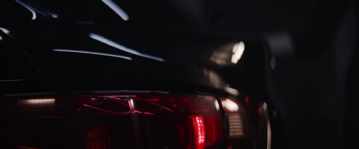 A car reflects light while sitting indoors