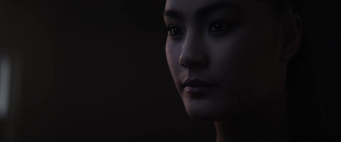 An asian woman looks around a room