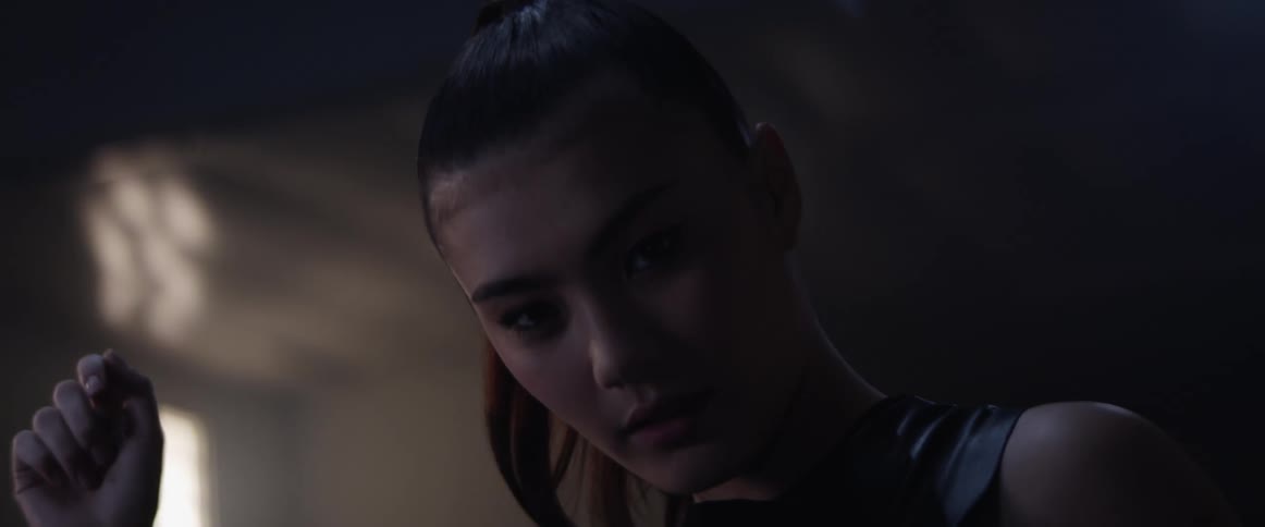 A woman moves her head under the flashing lights