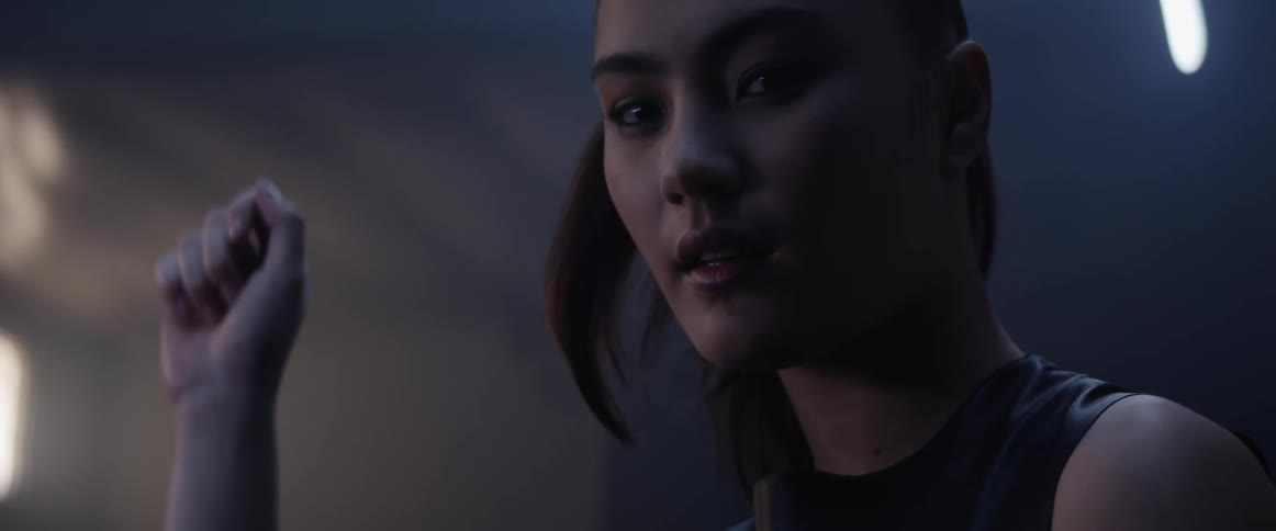 A young asian woman indoors looks around the room