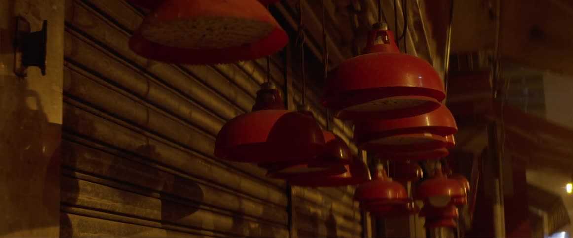 Red light fixtures hang outside of a store