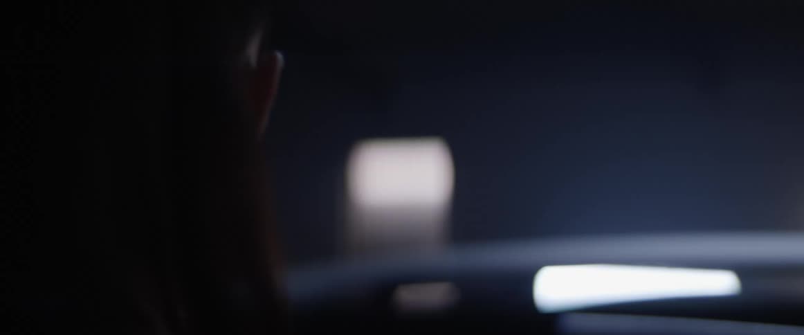 A woman standing in a room with flashing fluorescent lighting
