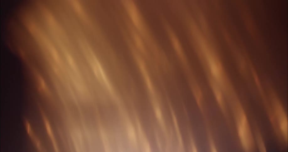 Golden streaks of light move in a stream