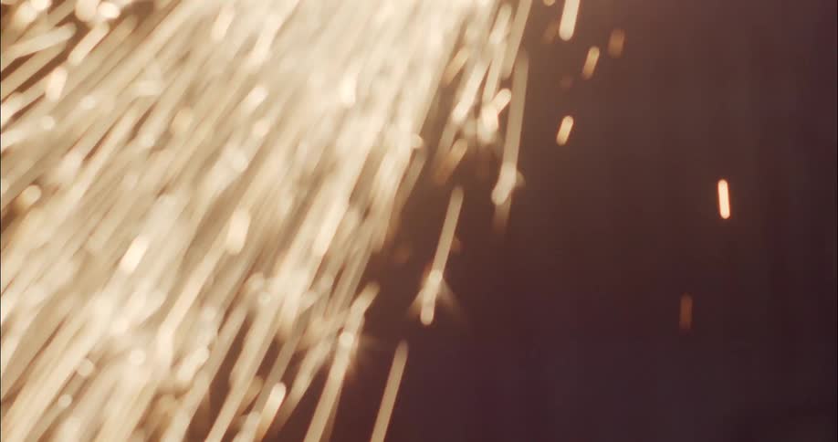 Yellow sparks shoot out in the dark