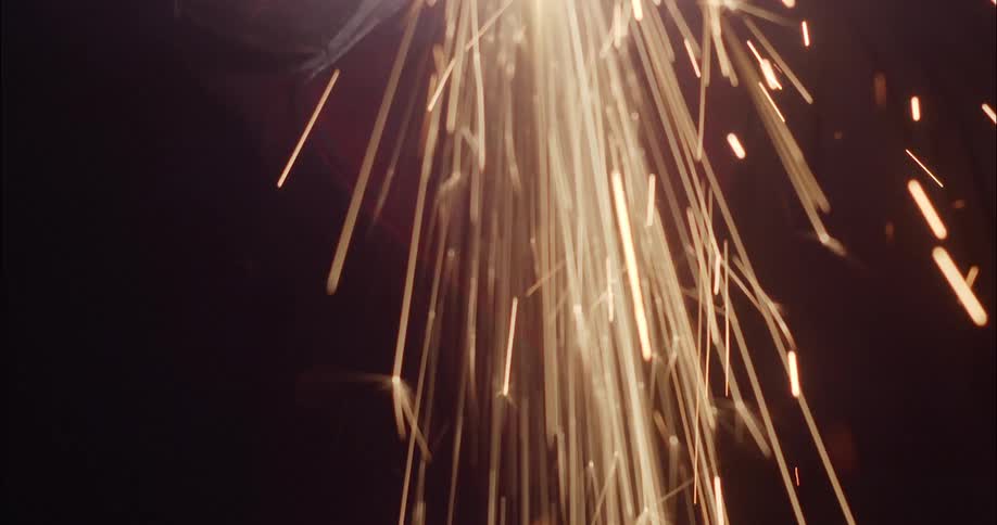 A welding tool throws off streams of sparks