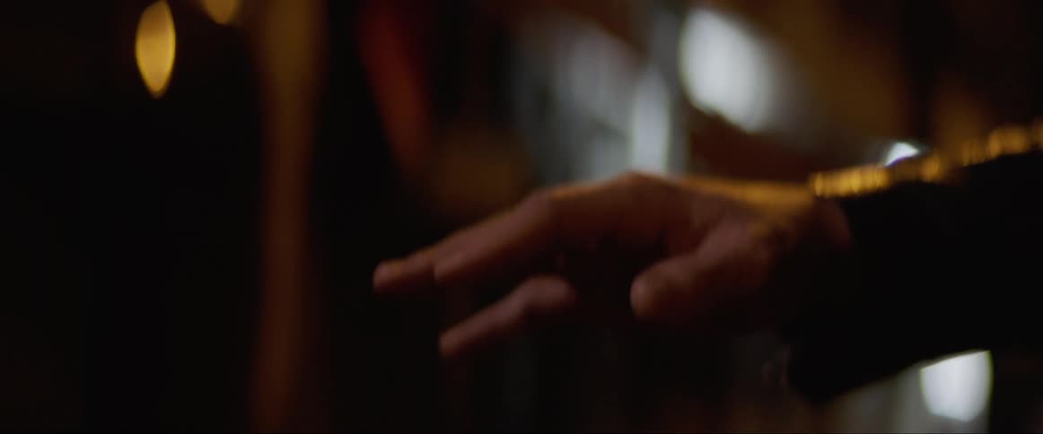 A white man stretches out his hand and moves his arm back and forth