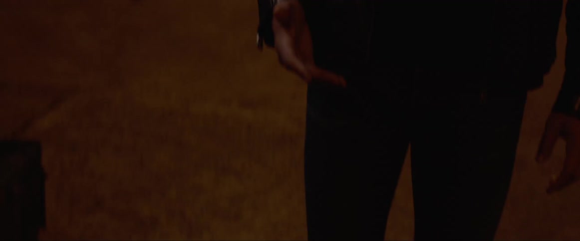 Man stands and looks perplexed in the street at night