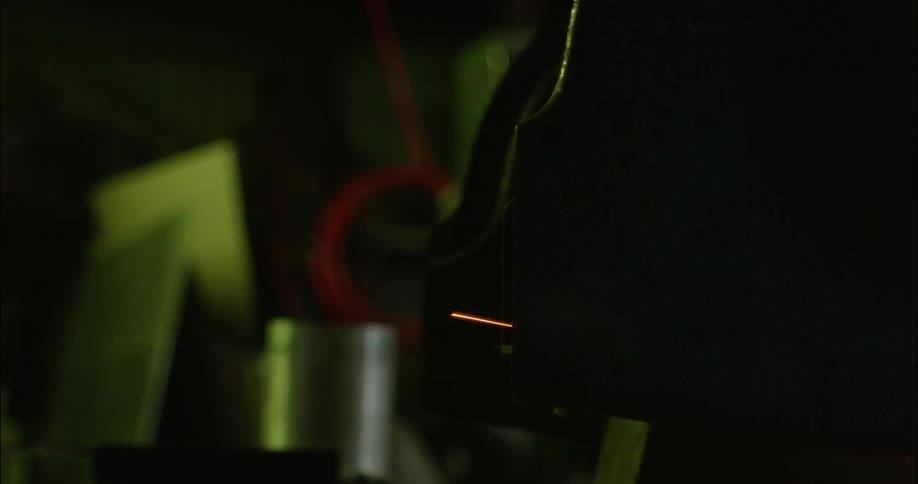 Sparks fly out of a piece of equipment in a workshop