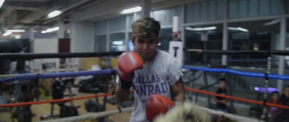 Teenage boys box in the ring