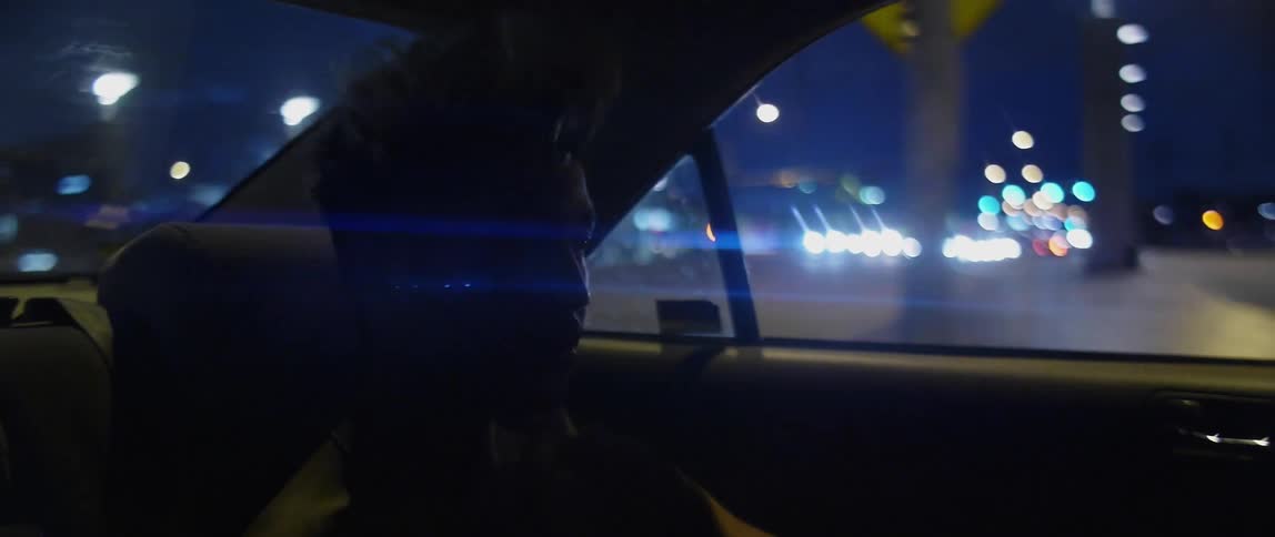 Passenger travels in a vehicle in the city at night