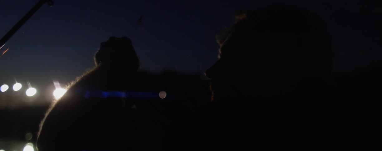 A white man jerks his head suddenly while doing night fishing