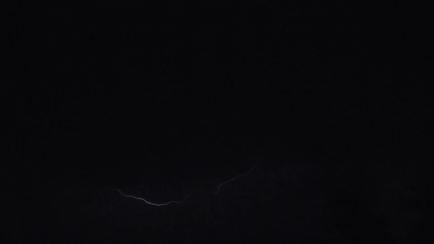 Lightning bolt through the clouds on an electric storm at night