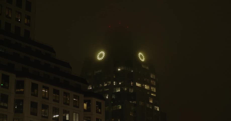 Two circular lights on the tall building shines bright